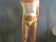 Panty sissy models his string bikini.